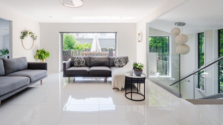 A modern home interior with large, glossy floor tiles