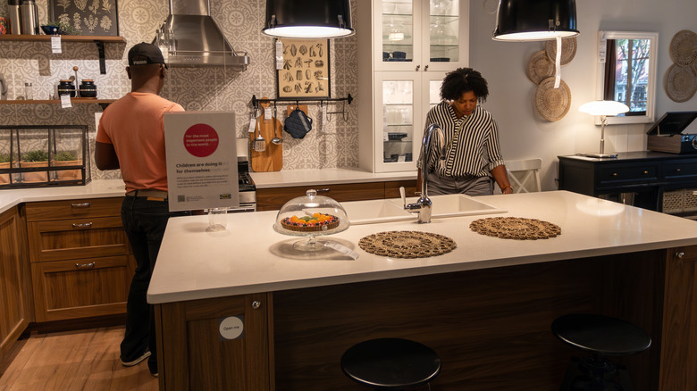 customers shopping in an IKEA kitchen showroom
