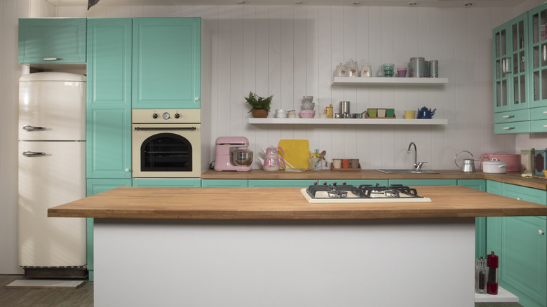 interior shot of a kitchen with bright teal accents
