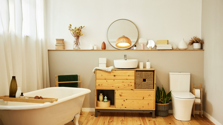 Wall to wall wood shelf above toilet