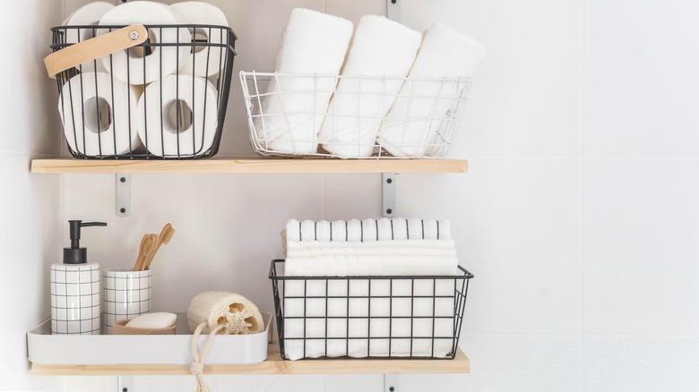 Wire baskets holding linens and toiletries
