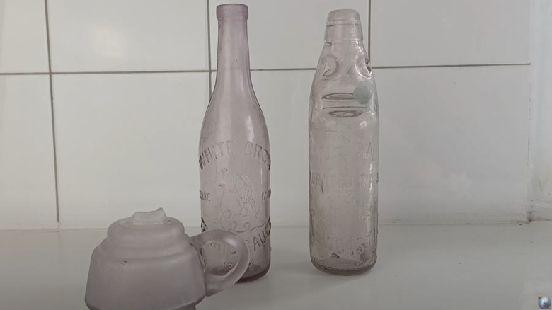 Purple tinted manganese glass bottles