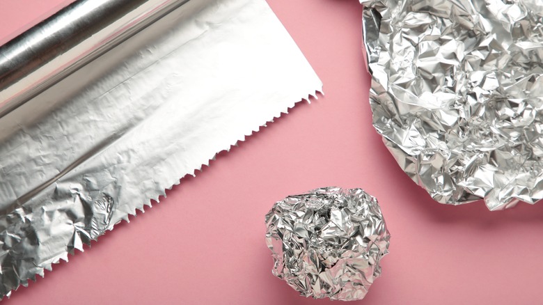 Roll of foil next to crumpled up pieces