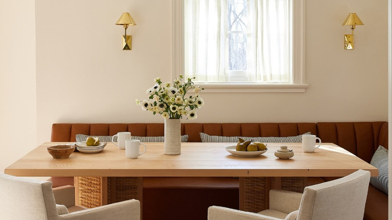 A breakfast nook with brassy light fixtures