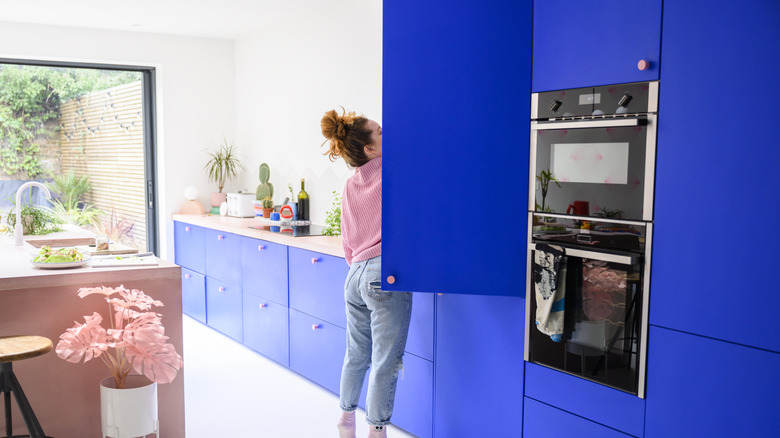 A modern kitchen with bright blue cabinets.