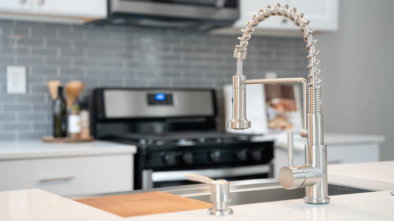 Close up of faucet in gray kitchen