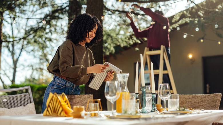 people decorating an outdoor space