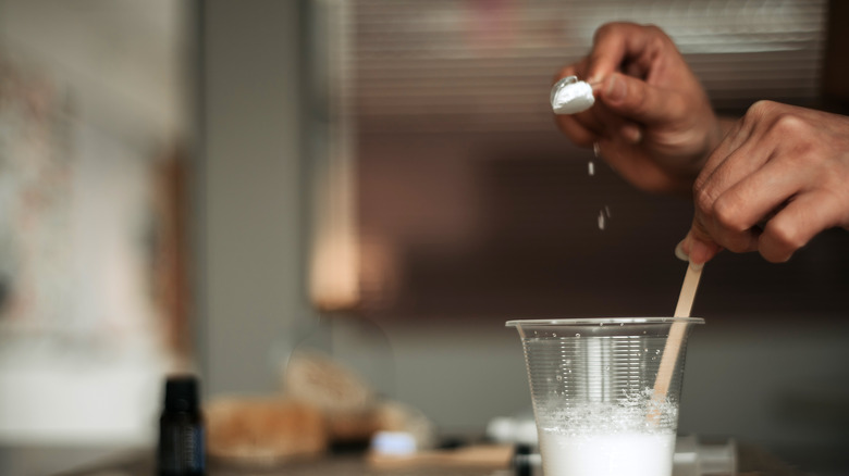 Close up of women mixing baking soda and water
