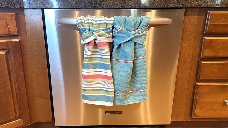 Two tea towels hang from oven door.