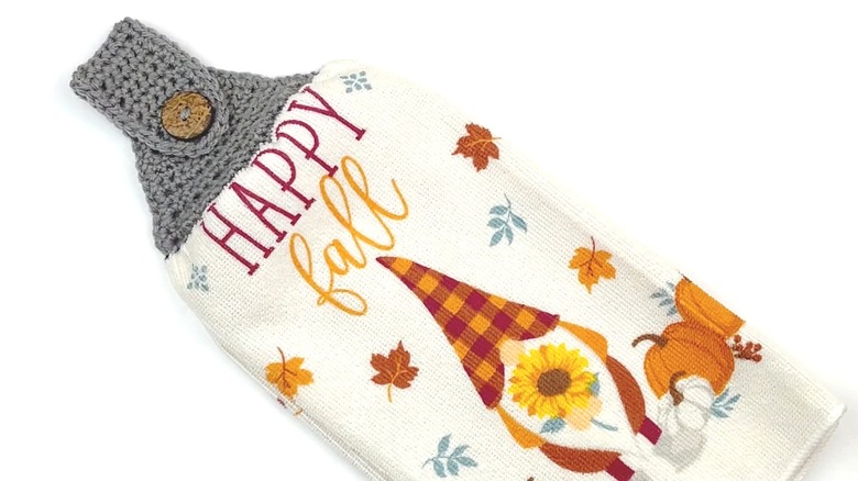 Fall-themed tea towel with a crochet topper for hanging.