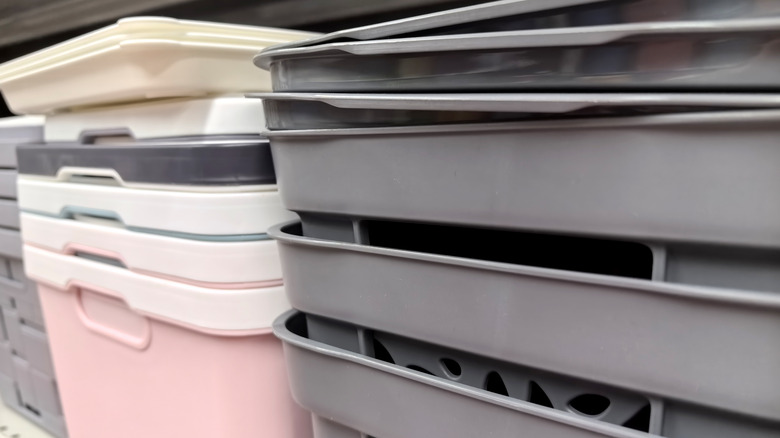 A close up of different colored bins stacked within each other.