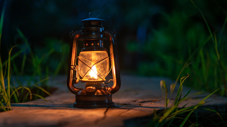 An antique oil lamp glowing cozily in the dark