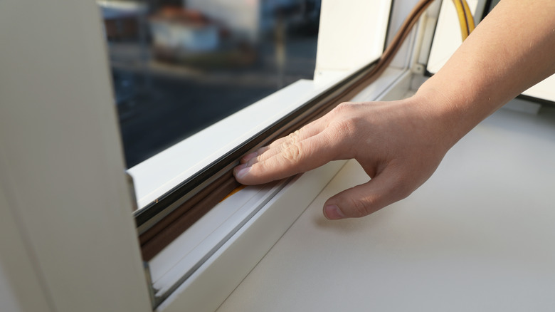 A hand adding a seal to a window