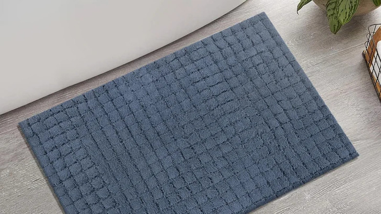 A plush bathroom rug on the floor.