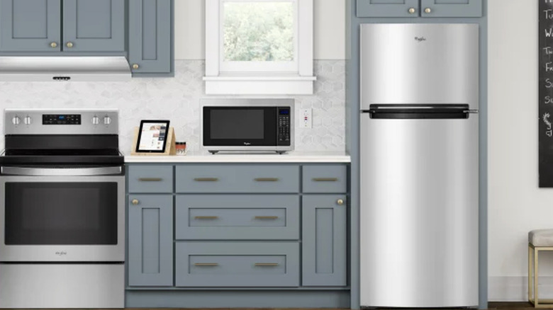 A kitchen set up with a Whirlpool freezer and refrigerator appliance.