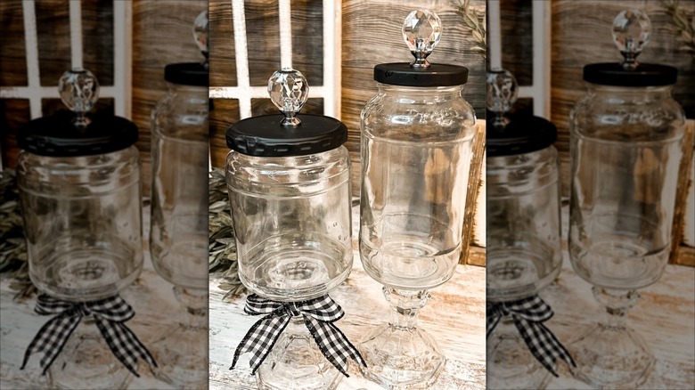 Two upcycled jars with candlesticks as bases