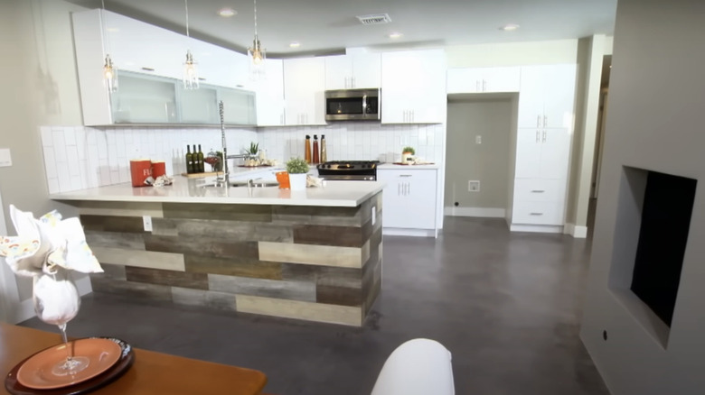 A gray modern open kitchen and living space.