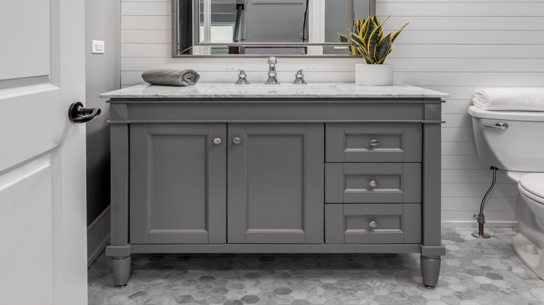 A modern bathroom with shiplap walls.