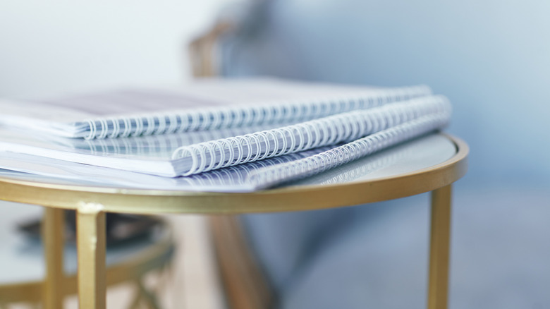 Spiral notebooks on side table