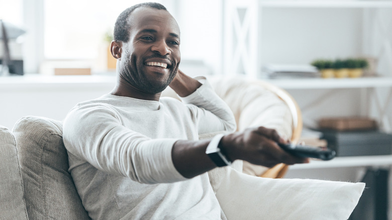 man holding TV remote