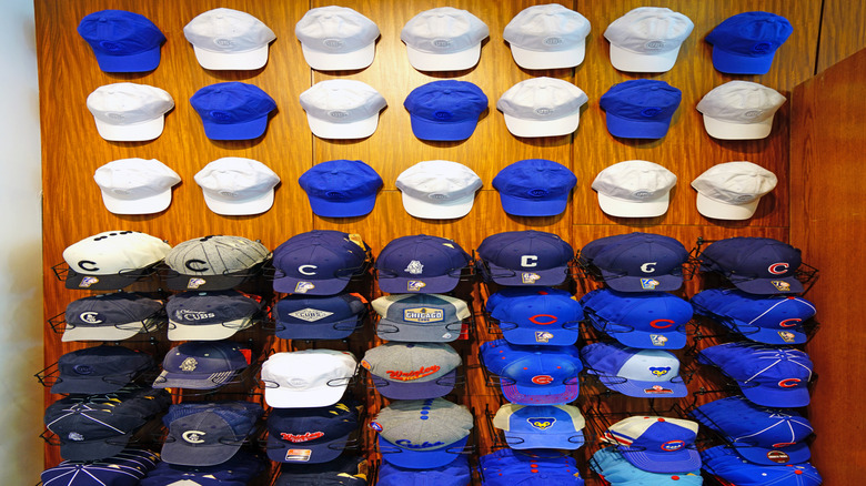 White and blue hats displayed on wooden wall