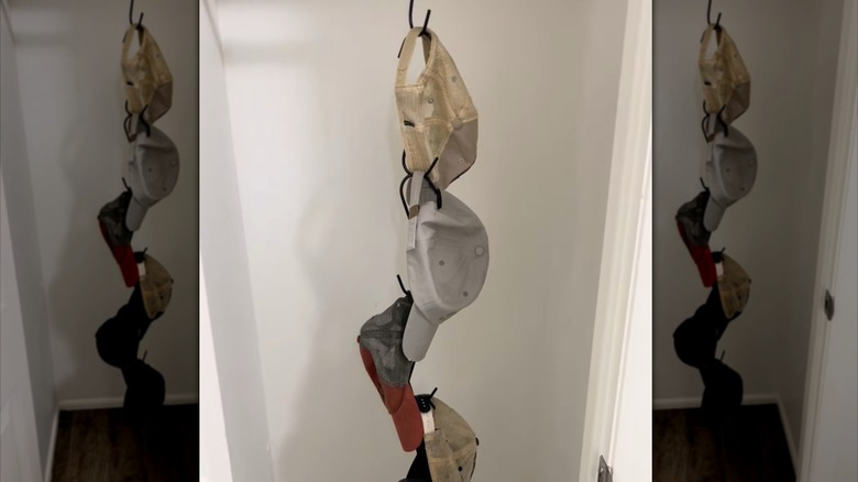 Hats hanging vertically on S hooks in closet