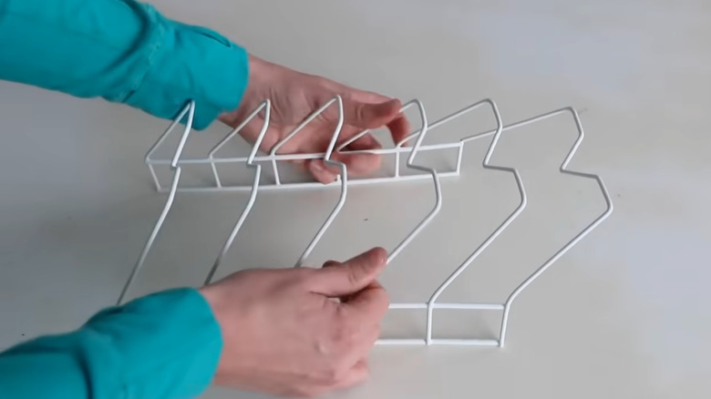 Woman's hands bending a wire dishrack