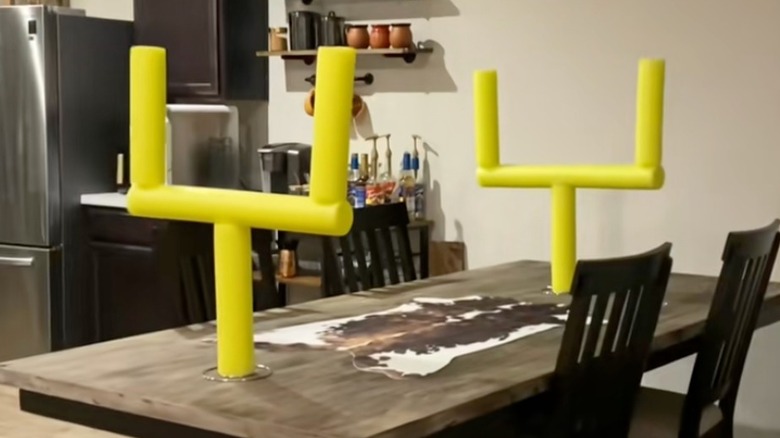 Two DIY field goals placed on each end of a kitchen table