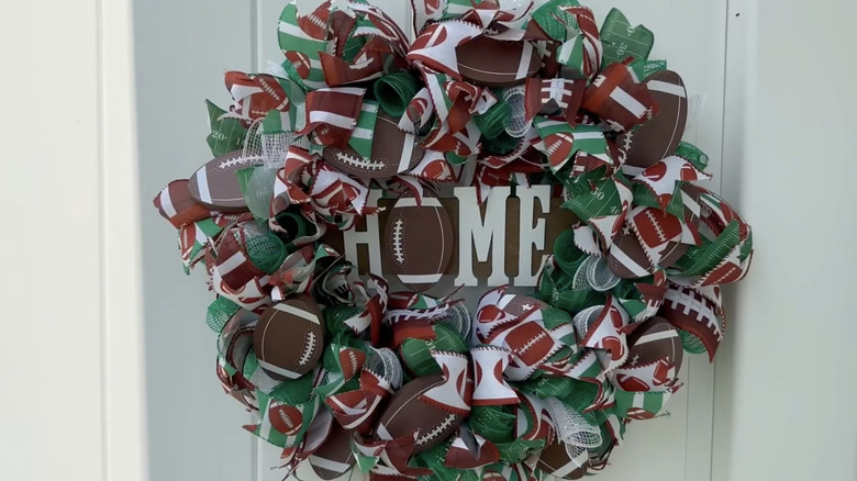 A front door wreath decorated with football imagery