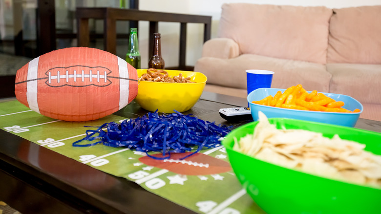 A table display with football related snacks and decorations