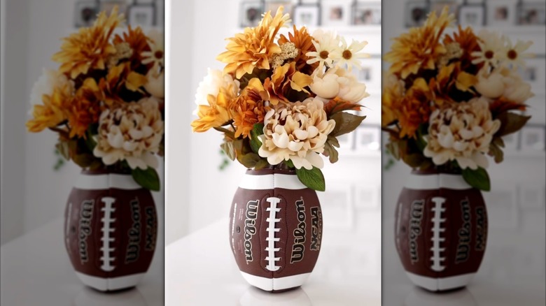 A floral arrangement with a vase that looks like a football