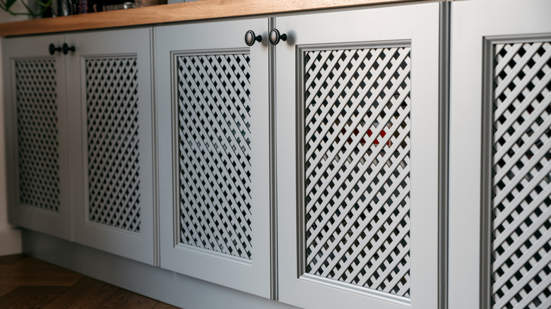 White cabinets with rattan mesh fronts