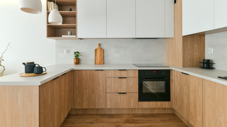 Minimalist kitchen with light wood cabinets