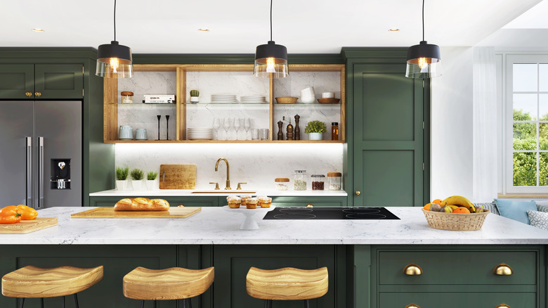 Dark green kitchen cabinets featuring open shelving