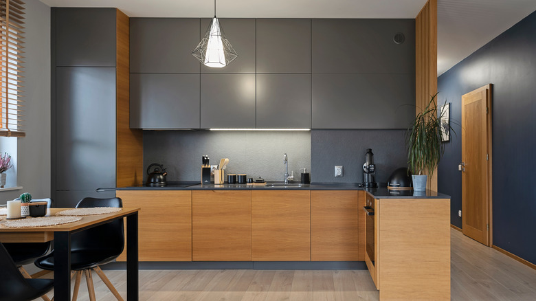 Kitchen with flat black and wood cabinets
