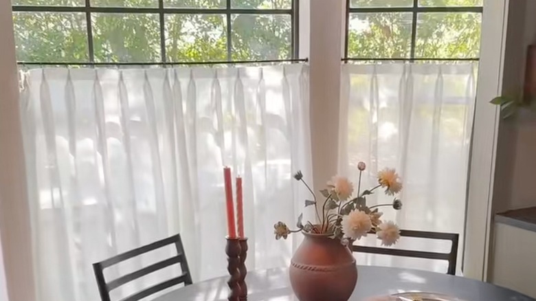 White cafe curtains hung in a kitchen window