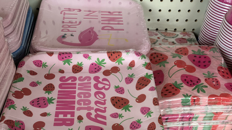 Plates and napkins with pink strawberry designs.