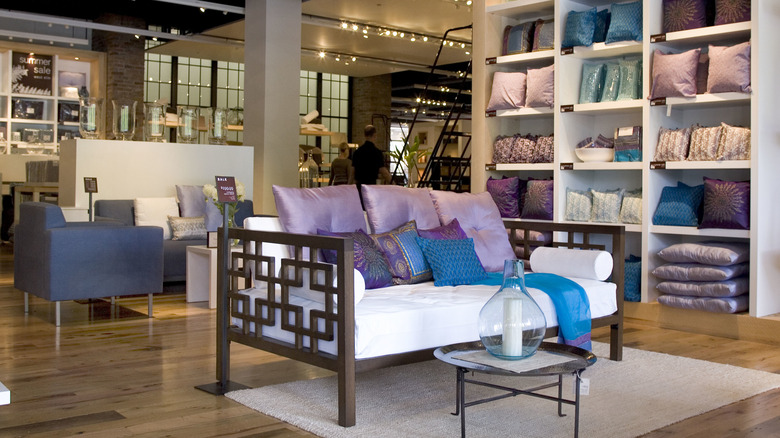 A collection of blue and purple pillows inside a West Elm store.