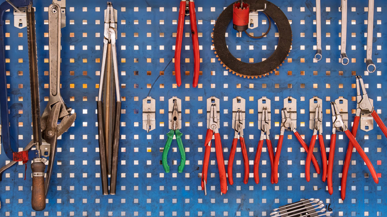 A pegboard with tools on it