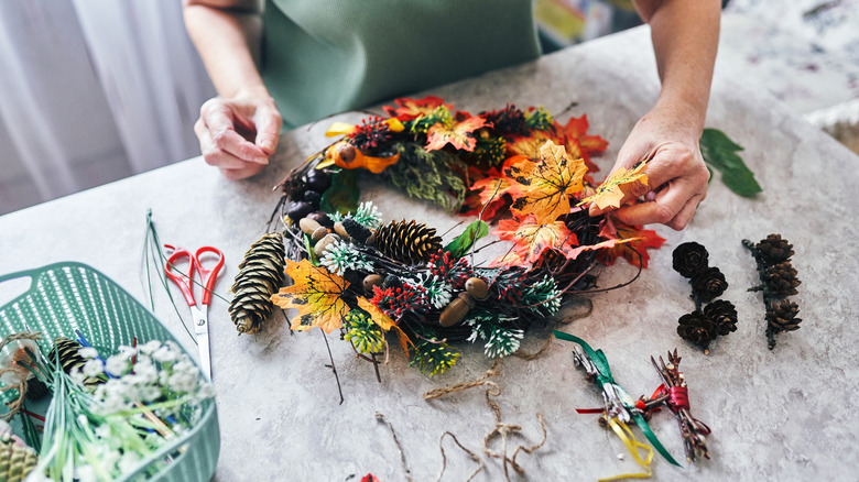 Person making fall wreath