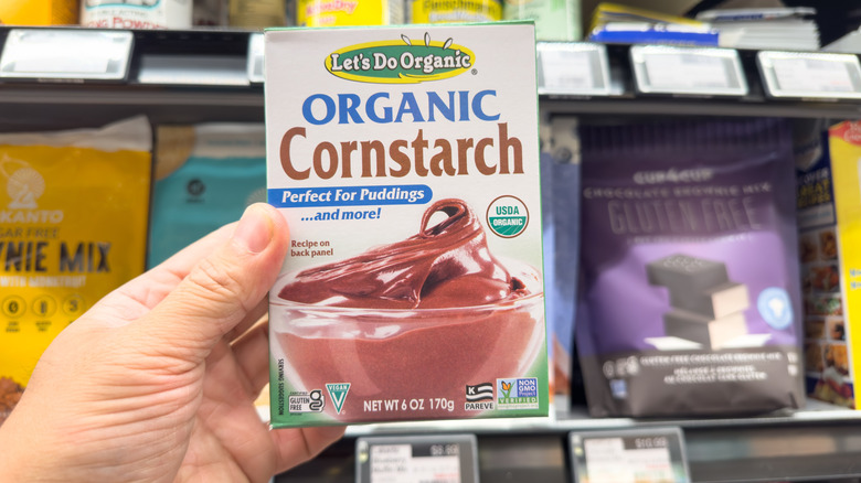 Hand holding a box of cornstarch