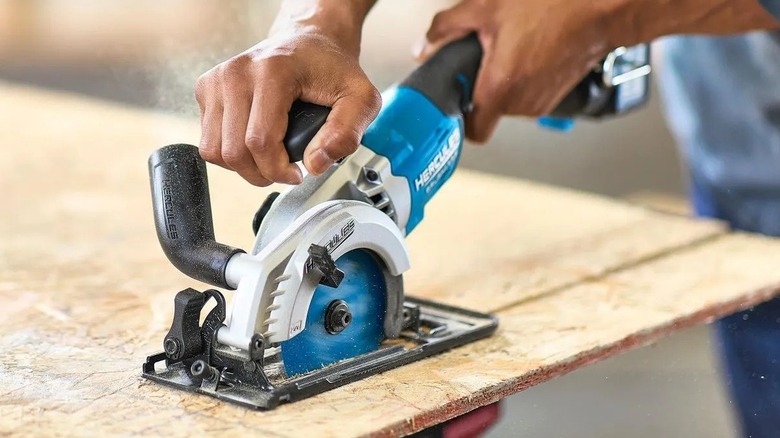 Person using a compact circular saw
