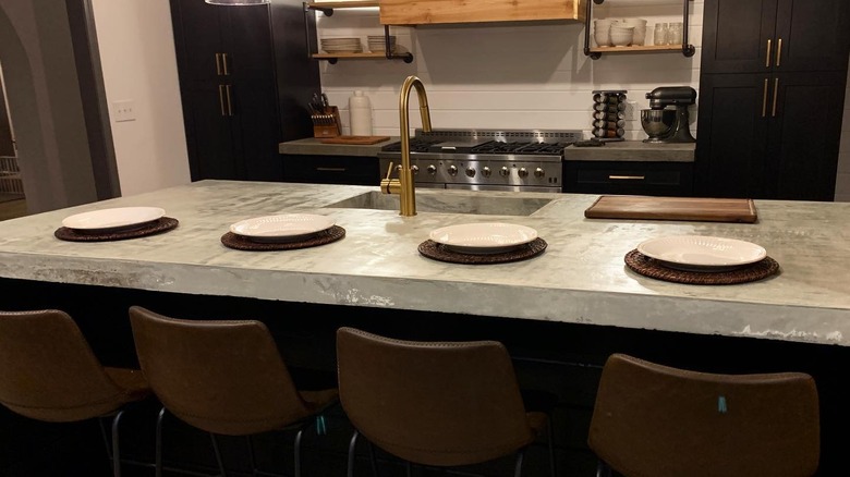 A kitchen with concrete countertops