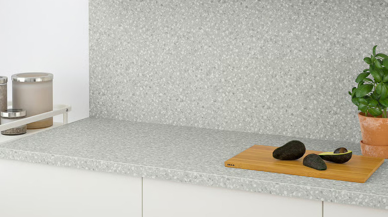 IKEA light gray laminate countertop with avocados and cutting board