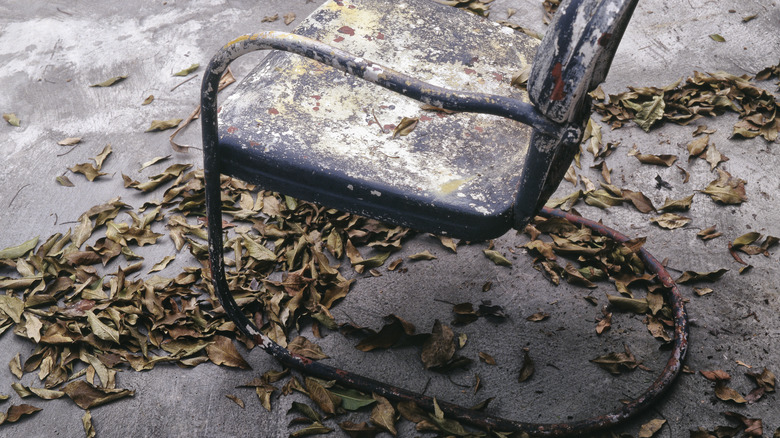 View of a rusty old chair on concrete