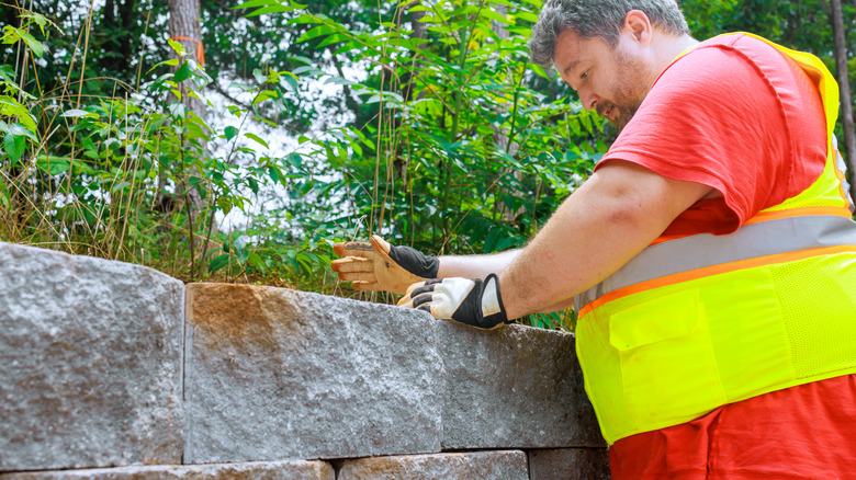 A professional working on a garden wall