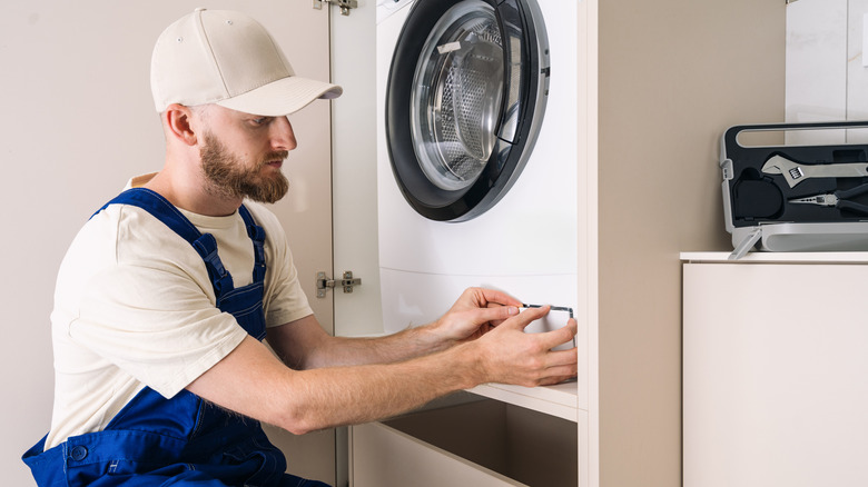 technician working on washing machine