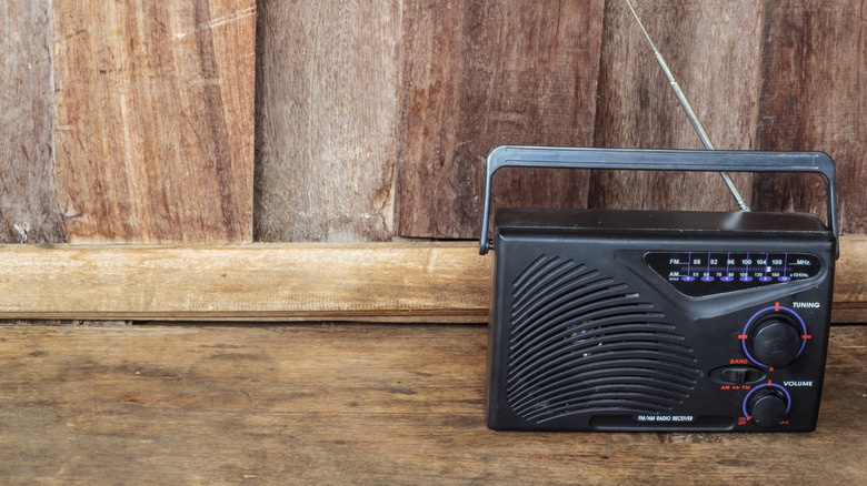 A portable radio is set up in a rustic-looking room
