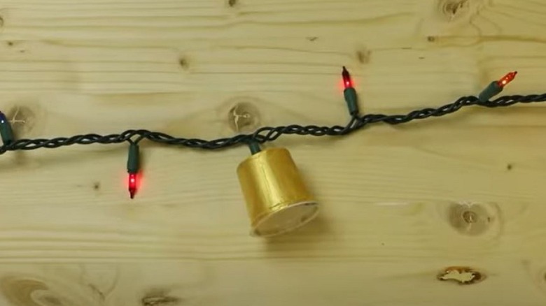 String lights with empty coffee pod around one bulb