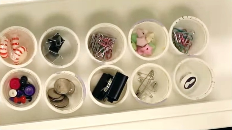 Coffee pods in desk drawer as office supply organizers
